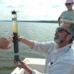 Marc Alperin examines a sediment core collected from Jordan Lake